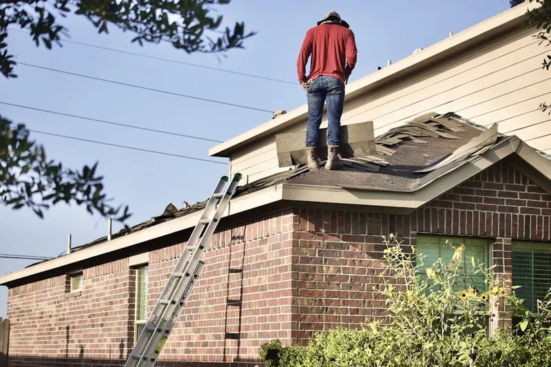 Professional roofer working on a residential roof in Upper Dutchtown